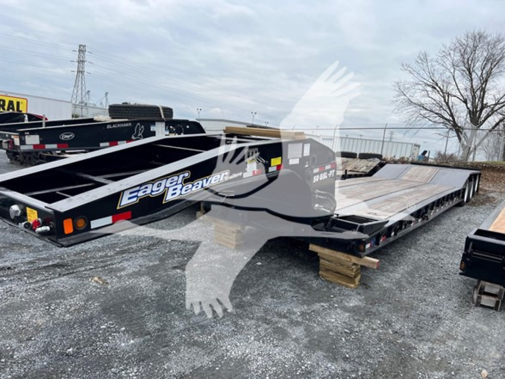 Heavy trailer showing Eager Beaver logo and '50 Ton Hydraulic Detachable Paver' branding on the side, with black paint and white lettering. VIN 112SE2469TL088055 and stock TL088055 visible on trailer frame.