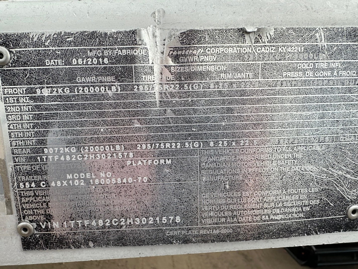 Trailer data plate on Transcraft Combo Flatbed showing vehicle information and specifications plate with multiple etched lines.