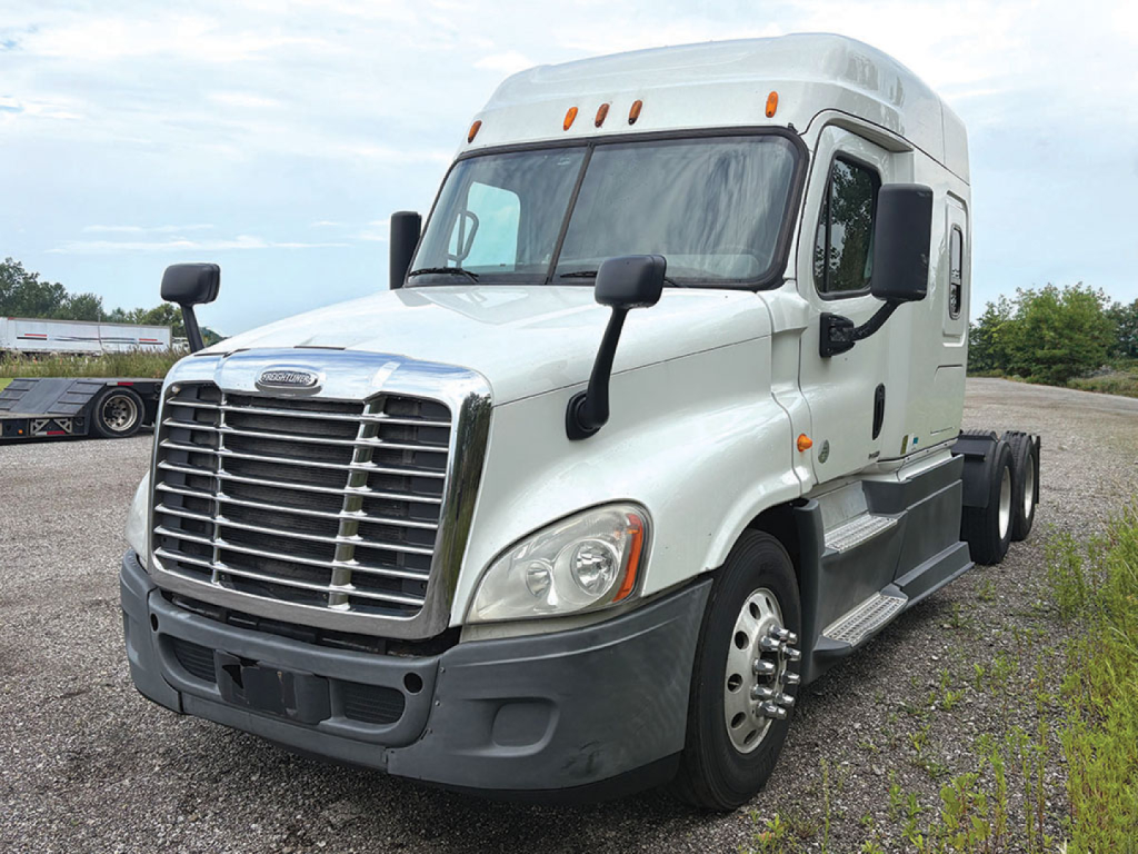 Truck cab exterior of a 2014 Freightliner Cascadia125 Conventional Sleeper showing front grille, headlights, and side mirrors.