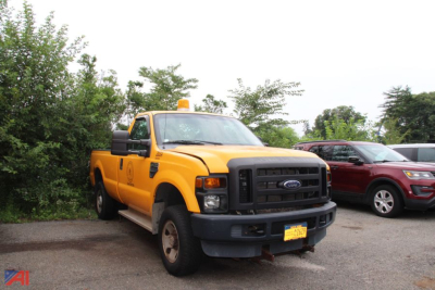 Ford F-250 Super Duty pickup truck in service yellow with amber beacon light on top, front grille, and side mirrors visible.