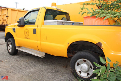Ford F-250 Super Duty pickup in yellow, side view showing extended cab, cargo bed, and warning light on roof.