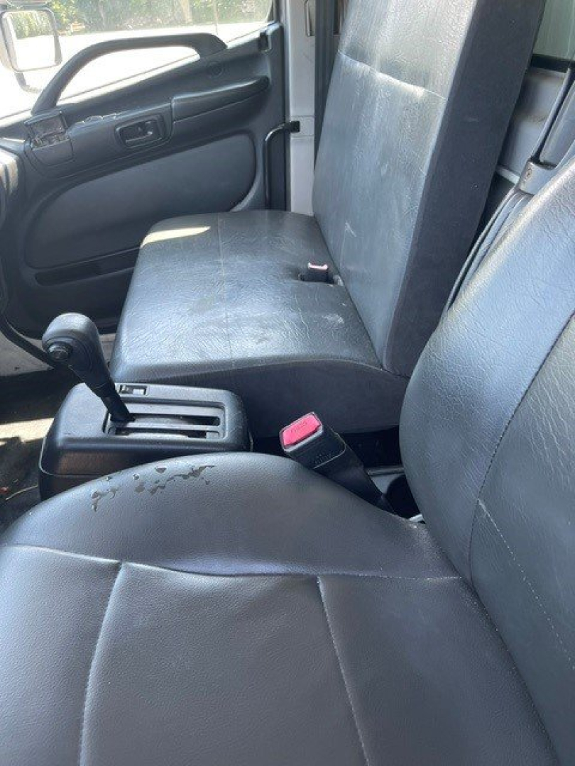 Truck cab interior showing seating and gear shifter area in a 2014 Hino 258/268 reefer truck.