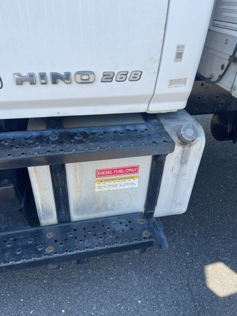 Hino 268 side view showing diesel fuel only label on fuel tank; diesel fuel warning sticker visible under cab with steps.