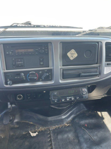 Dashboard of a 2014 Hino 258/268 reefer truck showing climate controls, radio, and glove compartment area.