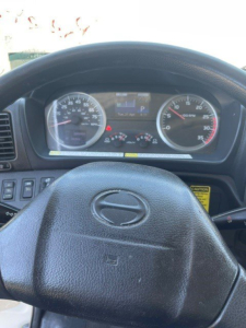 Dashboard view of a 2014 Hino 258/268 reefer truck showing steering wheel with Hino emblem and instrument cluster including speedometer and tachometer.