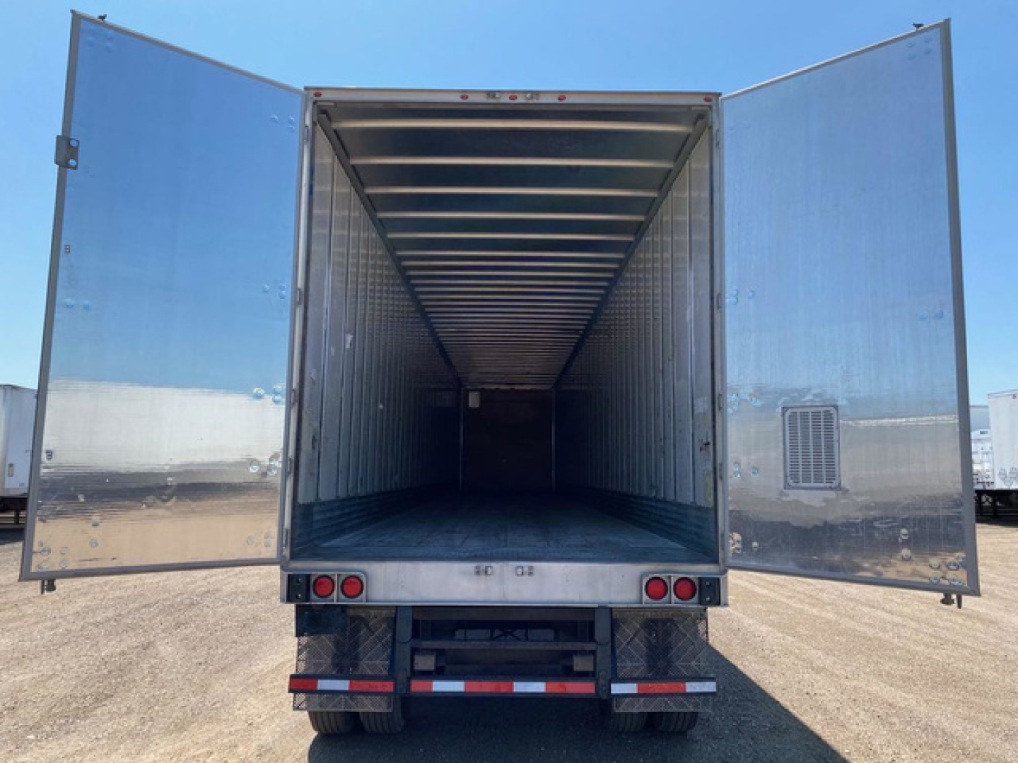 Trailer interior view with rear doors open showing empty cargo space in a 2014 utility van trailer