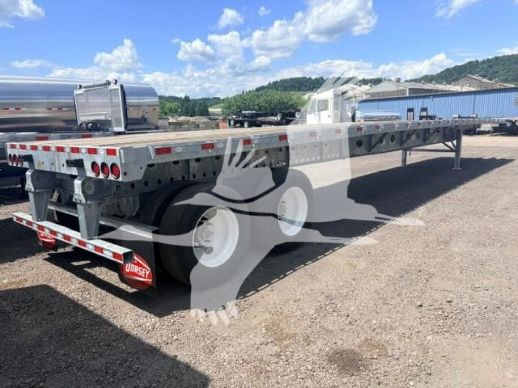 Flatbed trailer showing aluminum frame and dual rear ramps with Dorsey branding and reflective tape.