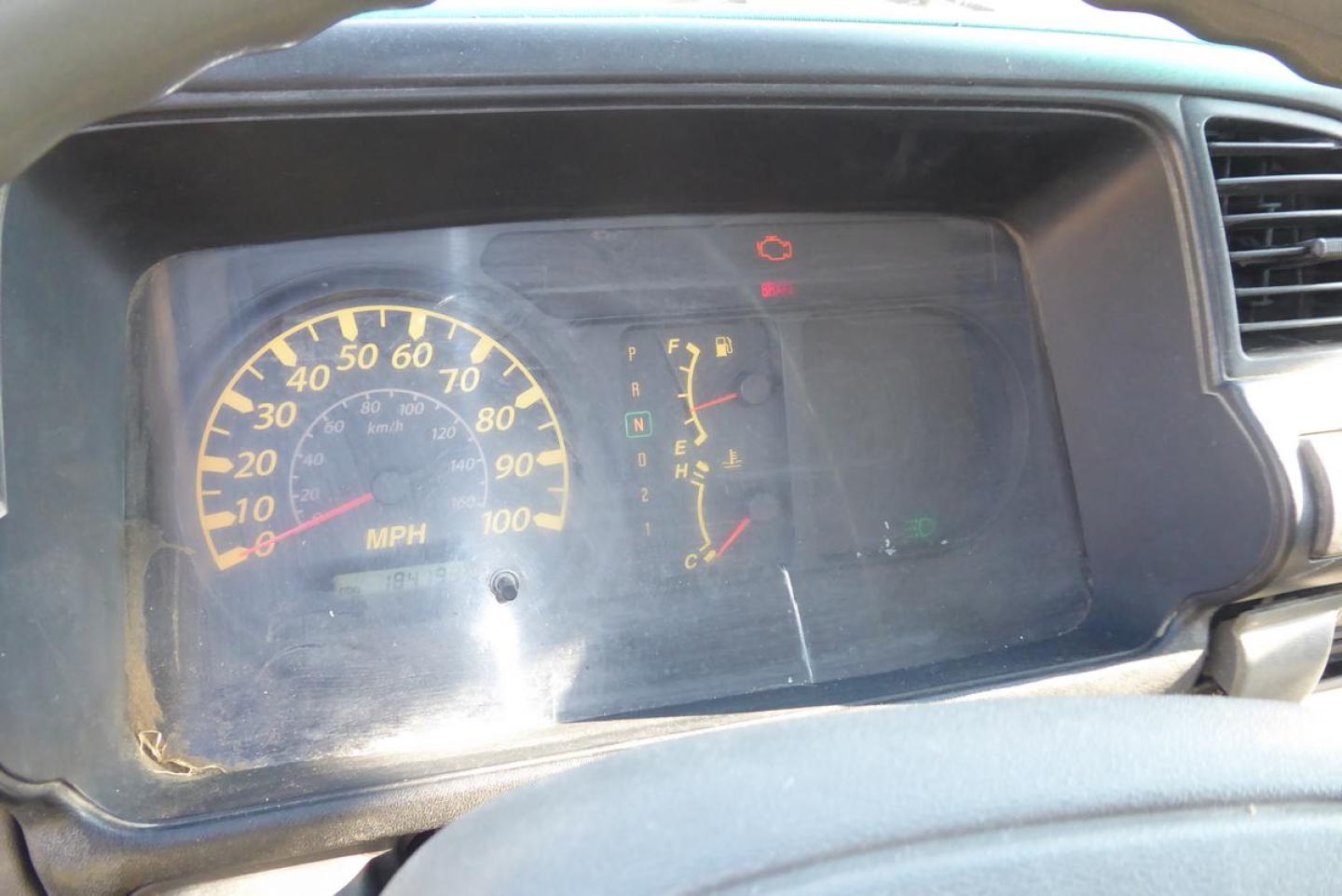 Dashboard of a GMC W4500 truck showing speedometer with MPH scale, fuel gauge, and warning lights