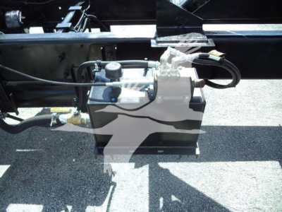Hino 268A undercarriage showing hydraulic pump and lines with control valve mounted on frame.