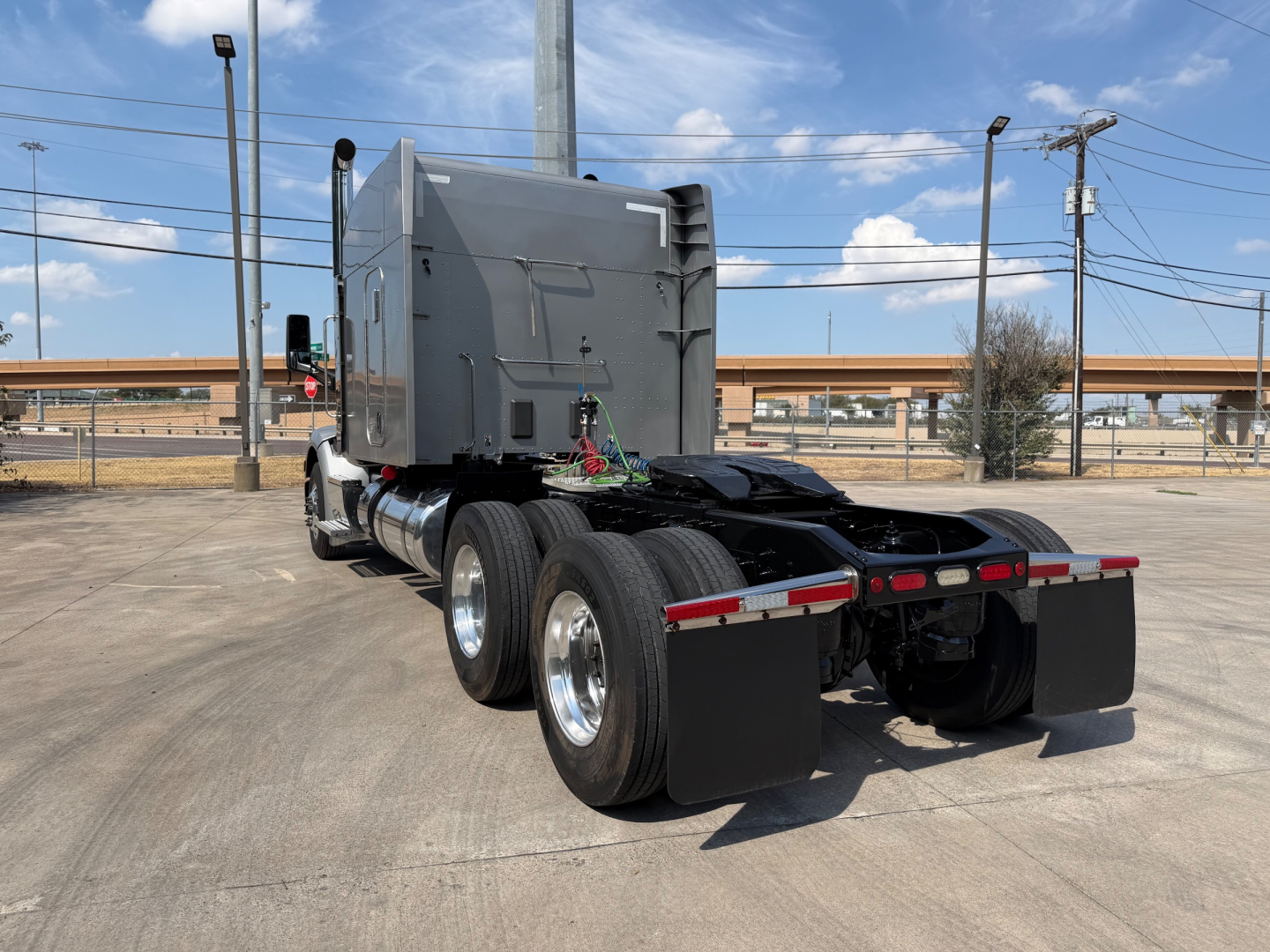 Peterbilt 579 truck tractor rear view showing dual rear axles and fifth wheel adapter.
