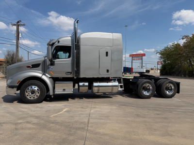 Peterbilt 579 conventional sleeper tractor in profile view showing cab with sleeper, chrome exhaust stacks, and dual rear axles.