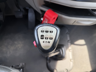 Peterbilt 579 interior view focusing on the gear shifter with a 10-speed manual shift pattern and surrounding dashboard area.