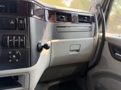 Peterbilt 579 interior dashboard view showing steering column area and glove compartment.
