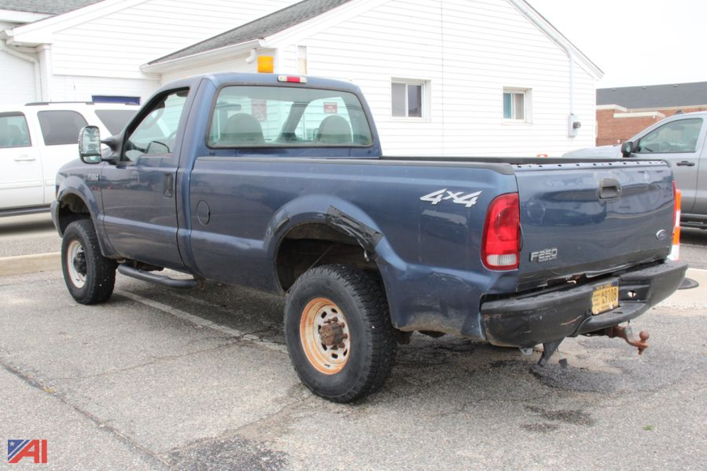 Ford F-250 Super Duty pickup truck 4x4 rear view showing truck bed and tailgate, blue cab with extended cab, dual rear wheel setup, F-250 badge.