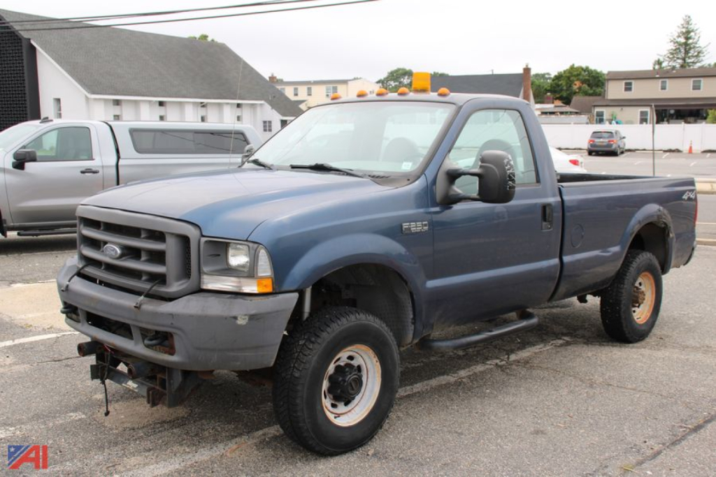 Ford F-250 Super Duty pickup truck in blue, single cab long bed, 4x4 with orange clearance lights on the cab roof.