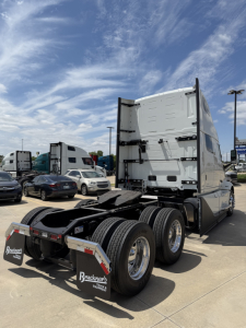 Volvo VNL64T860 truck tractor rear and chassis view showing tandem axles and fifth wheel, with tall sleeper cab and rear lights.