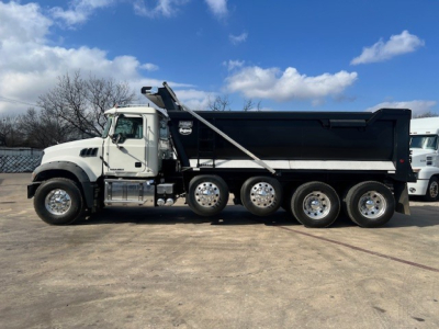 Dump truck side view showing 2018 Mack GU713 with black dump bed and six rear wheels, VIN 1M2AX04CXJM040189, stock B2883P.