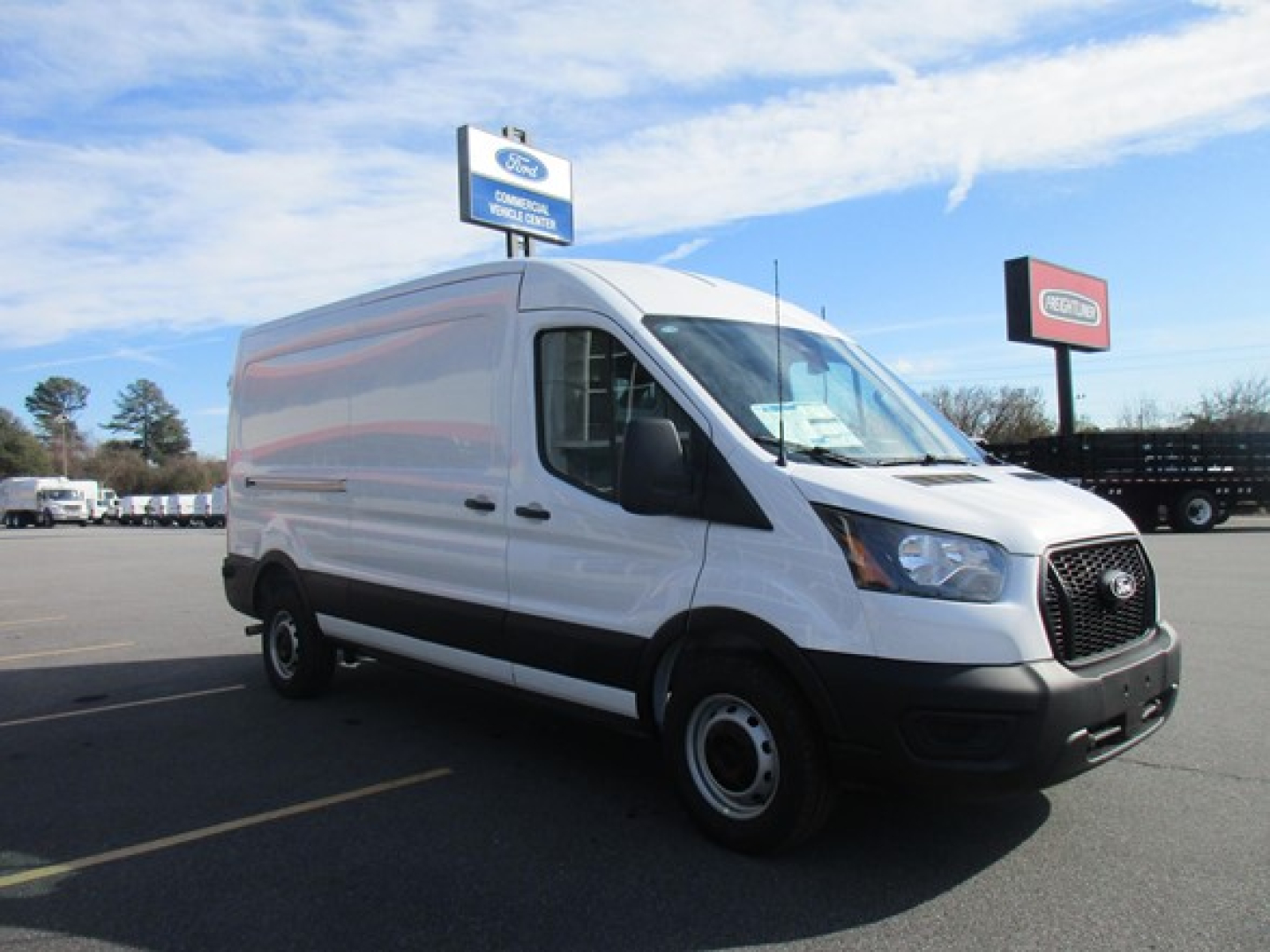 Ford Transit cargo van in white, side view showing front grille, headlights, and black front bumper.