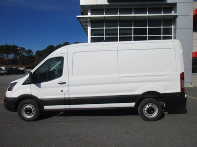 Ford Transit cargo van side view showing long body with plain white paint, black bumper, and steel wheels.