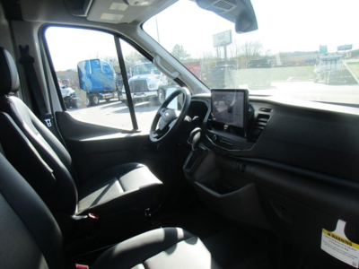 Ford Transit cargo van interior driver seat view showing steering wheel, dashboard, and touchscreen display.