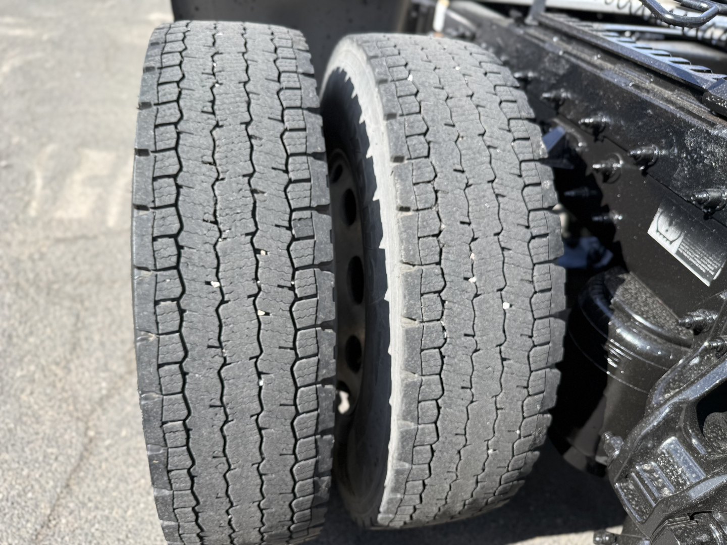 Conventional sleeper truck rear dual tires and drivetrain components visible in a 2019 Peterbilt 389 listing.