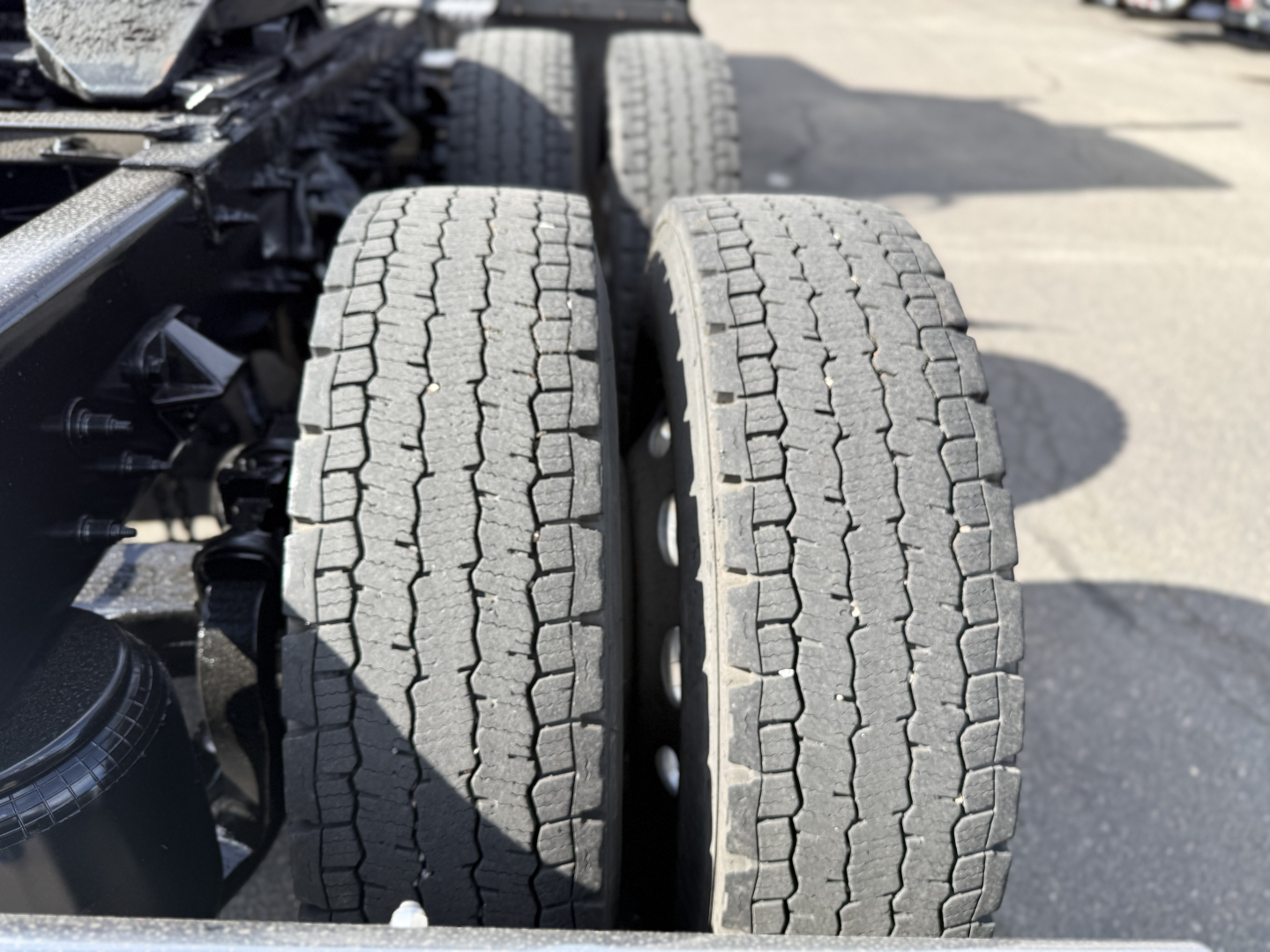 Two rear dual tires of a Peterbilt truck showing tread pattern and wheel rims.