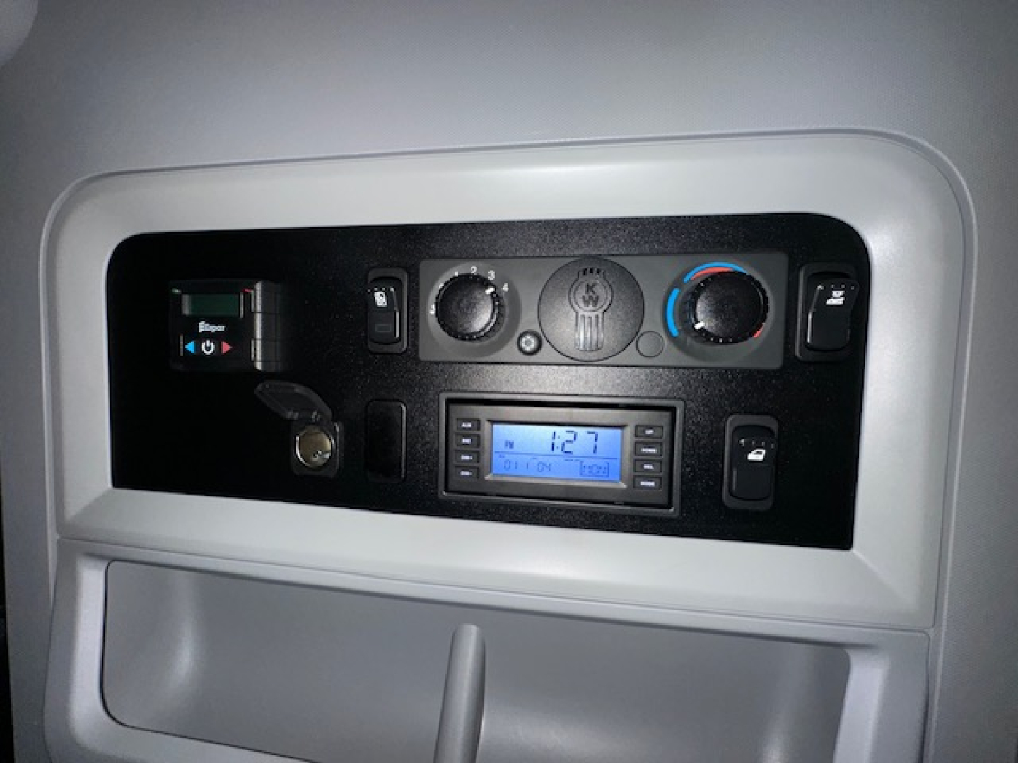Kenworth T680 dash panel showing HVAC controls, stereo head unit, and multiple switches in a sleeper cab.