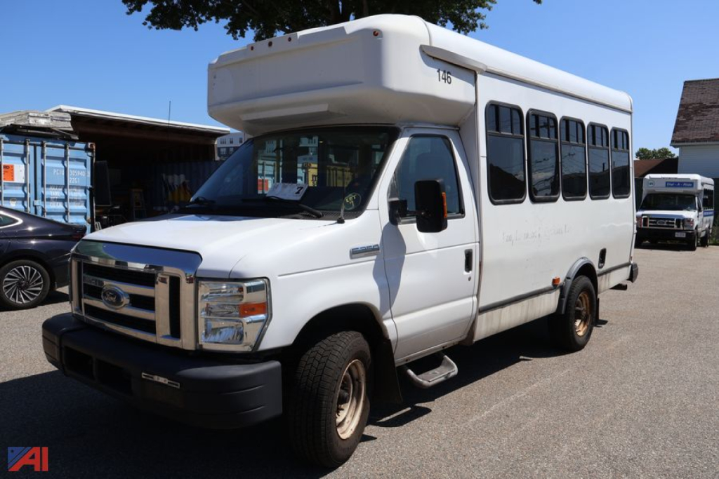 2017 Ford E350 wheelchair bus side view showing raised roof and windows.