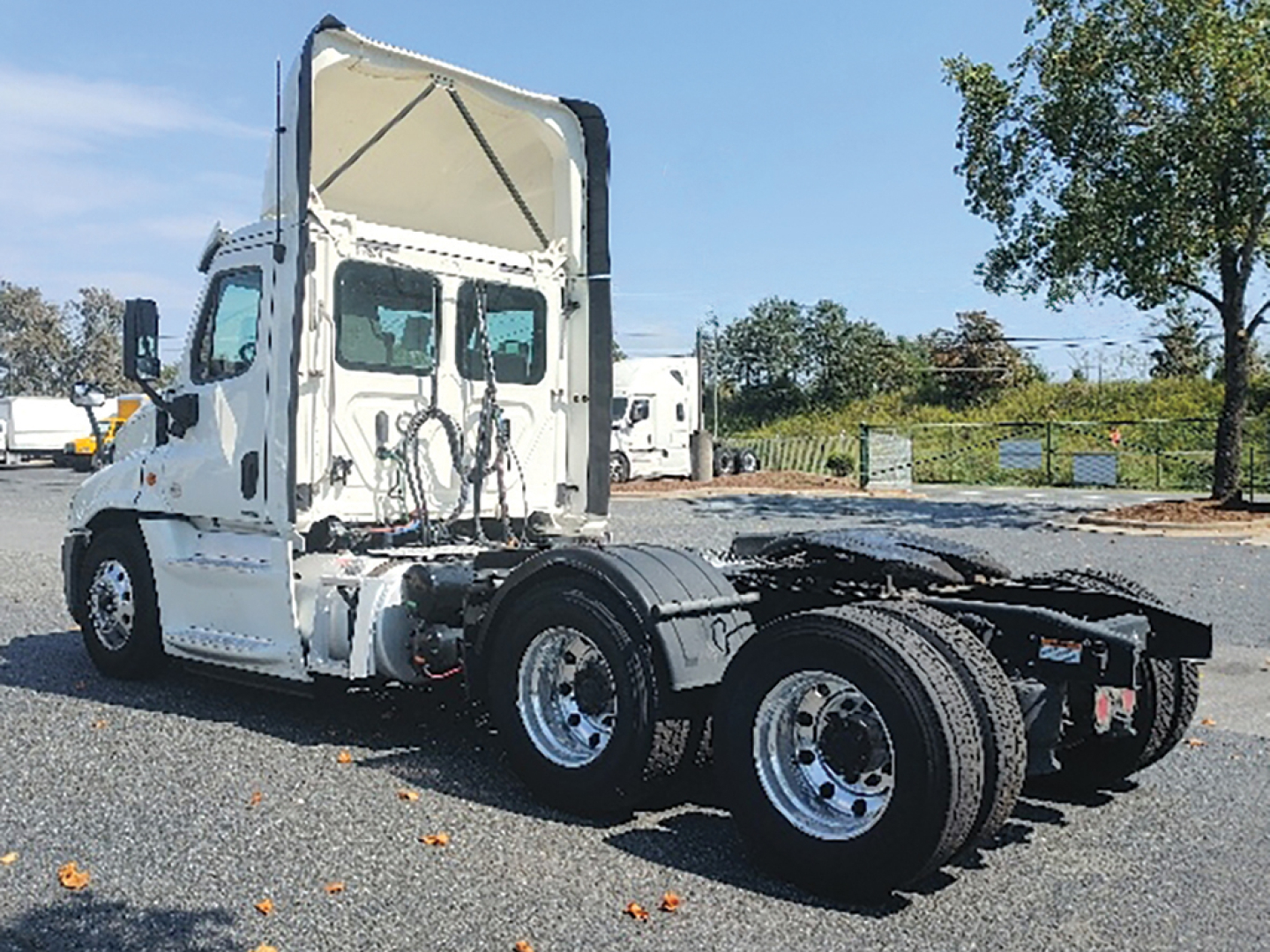Truck chassis and cab of a 2018 Freightliner Cascadia Evolution daycab showing rear tractors and fifth-wheel area with dual rear axles.