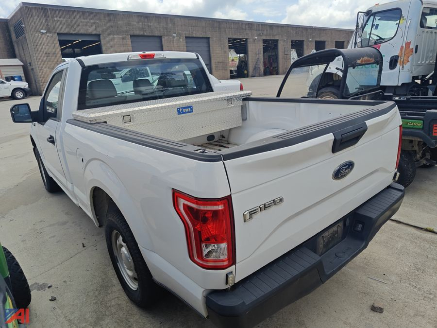 Ford F-150 pickup truck 2017 white crew cab with aluminum ladder rack and open bed.