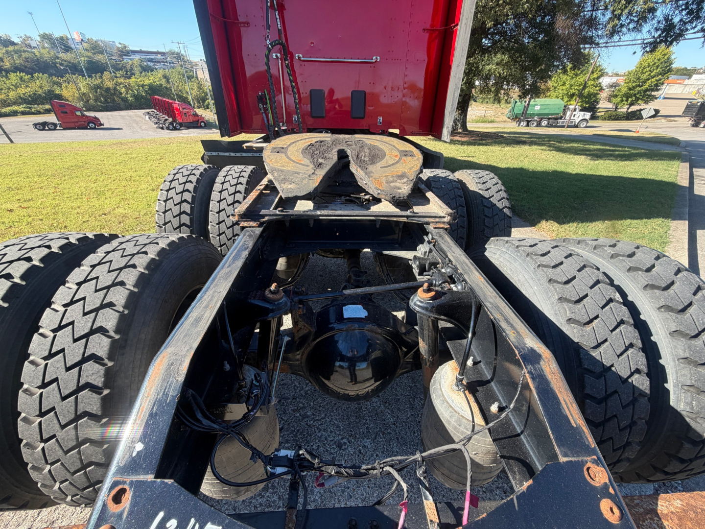 Peterbilt 579 chassis view showing rear dual drive tires and fifth wheel hitch with exposed axles and suspension components.