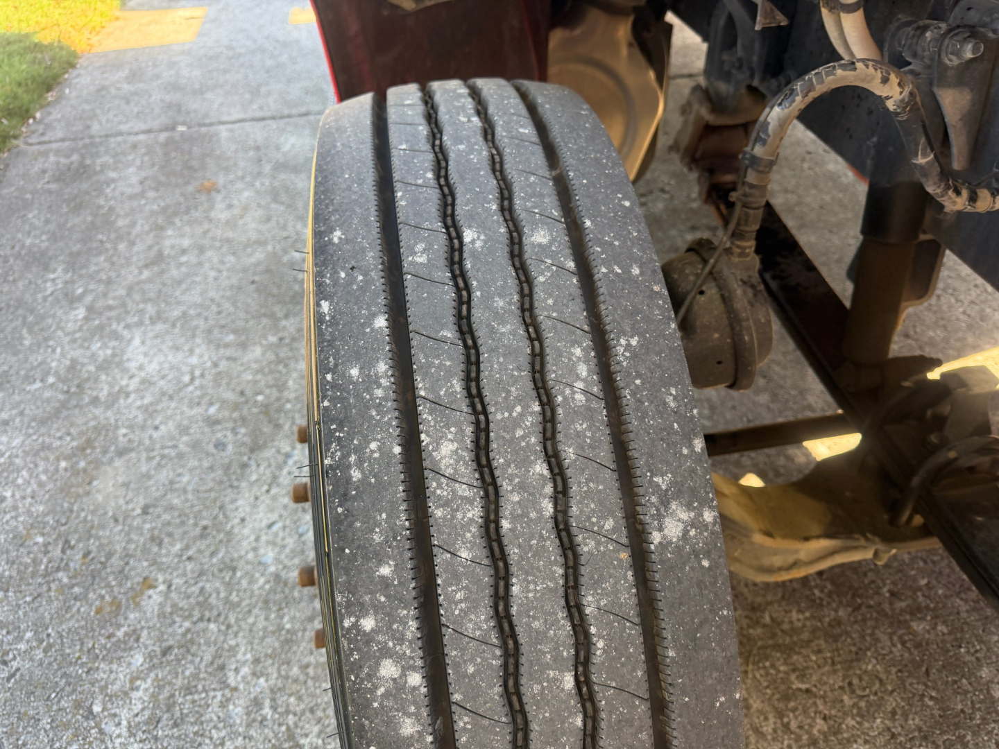 Peterbilt 579 truck wheel tread close-up showing several grooves and road grime on the tire.