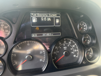 Peterbilt 579 dashboard view showing fuel economy display, RPM gauge, speedometer, and other indicators.