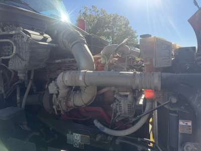 Peterbilt 579 engine bay showing diesel engine components and intake piping.