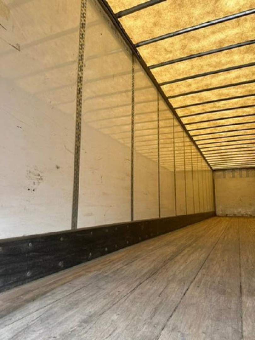 Inside of a 2016 Wabash van trailer with wooden floor and aluminum side walls; empty cargo area.