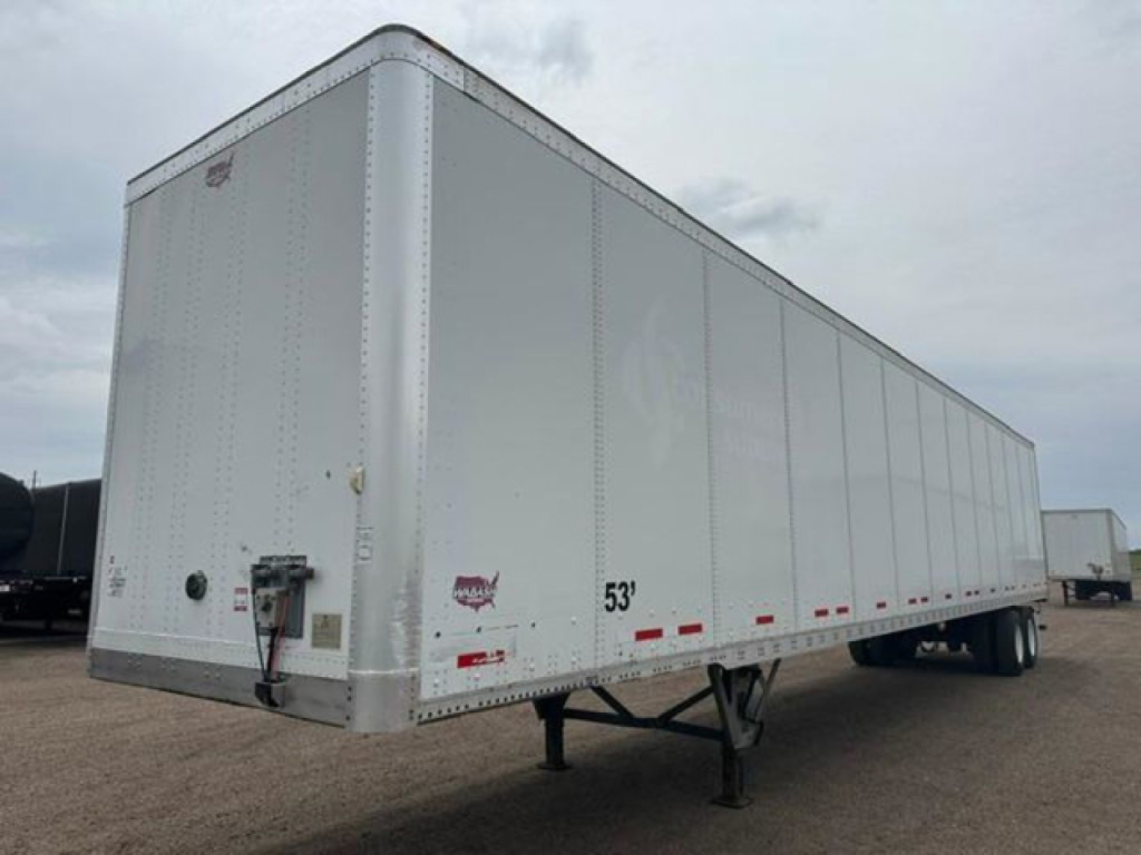 Trailer side view showing a 53' white Wabash van trailer with front access point, landing gear, and rear wheels visible.