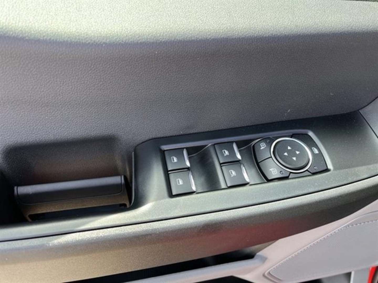 Ford F-350 cab and chassis door panel with window/mirror controls and storage pocket.