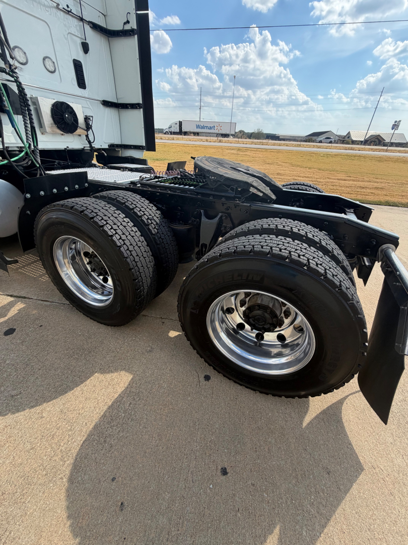 Truck rear dual tires and fifth wheel on a 2021 International LT625 tractor chassis showing dual rear axles and chrome wheels.