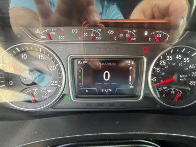 Dashboard of a 2021 International LT625 showing instrument cluster with RPM gauge, speedometer, digital display reading 0 mph, and various gauges, with VIN and stock number not visible on the dash.