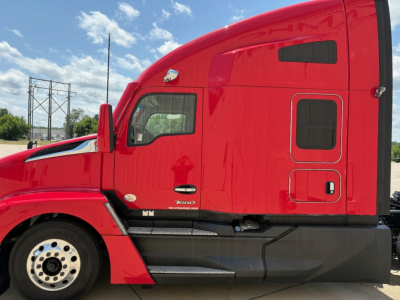 Kenworth T680 cab exterior side profile showing red sleeper cab and door, with side steps and black lower body trim.