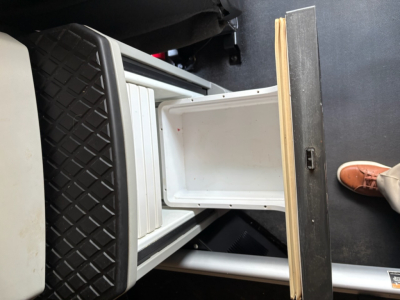 Kenworth T680 cab interior step storage showing under-dash compartments and entry area.