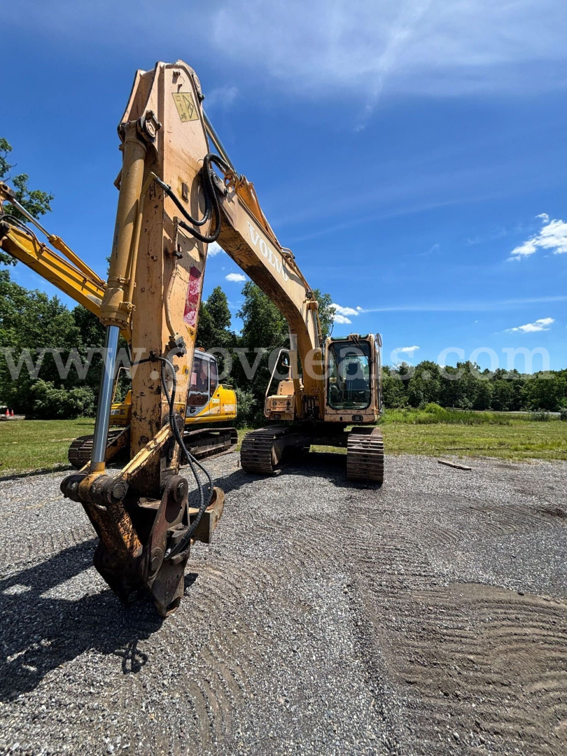 Volvo EC160B excavator in service showing long hydraulic arm and bucket attachment.