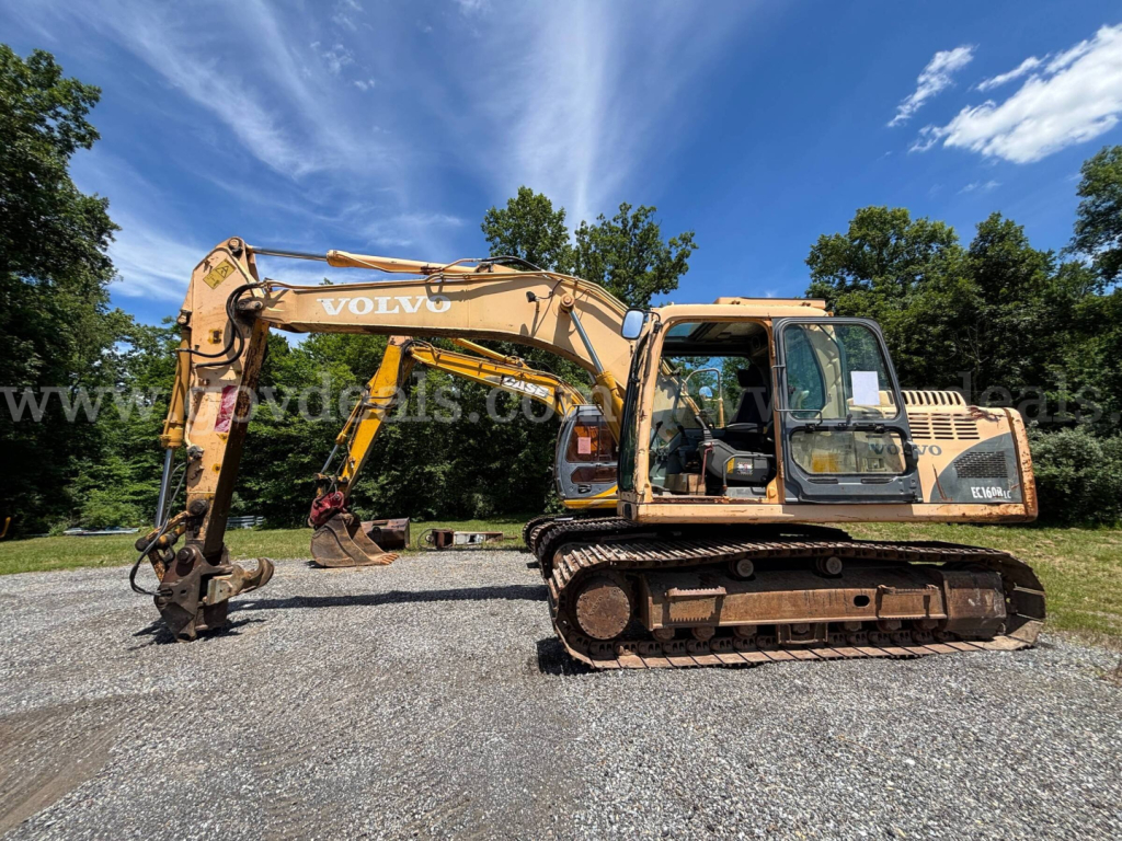 Volvo EC160B excavator side view showing hydraulic arm with bucket and tracked undercarriage; yellow paint with Volvo branding on arm; operator cab and engine compartment visible.
