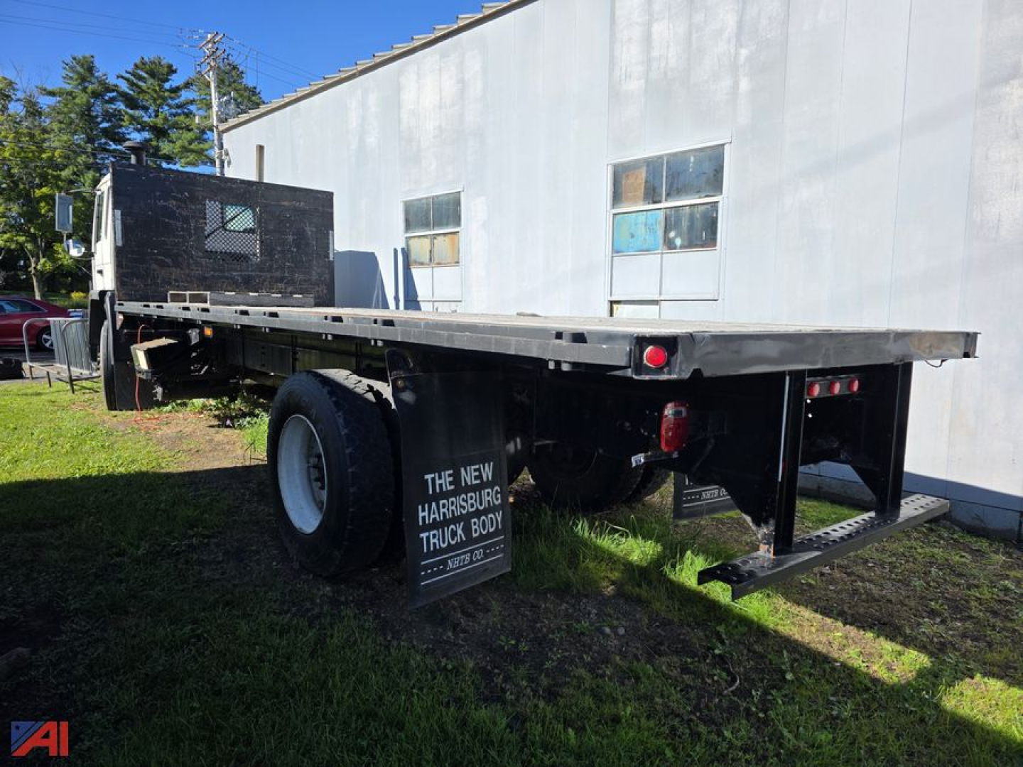 Flatbed truck chassis showing rear and side view with black gooseneck cabin and long steel flatbed, Volvo FE no model text visible.