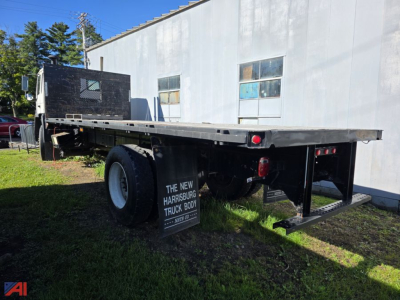 Flatbed truck chassis showing rear and side view with black gooseneck cabin and long steel flatbed, Volvo FE no model text visible.