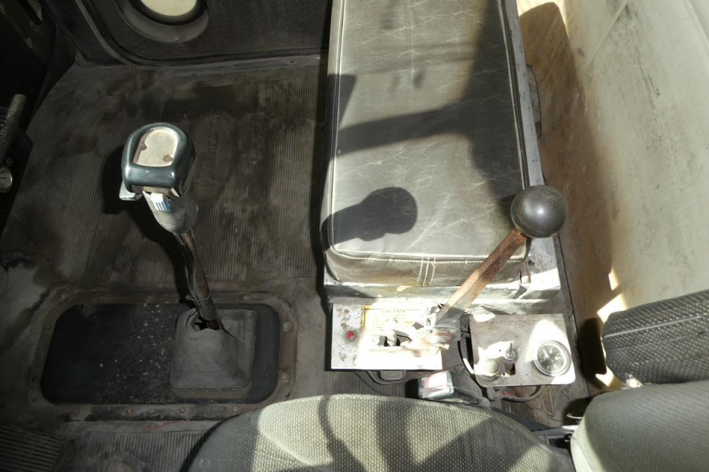 Peterbilt truck cab interior showing gear shifter and manual transmission lever in view.