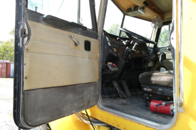 Peterbilt 357 dump truck interior view through open driver door showing dashboard and steering wheel.