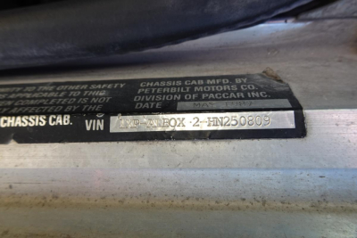 Chassis cab VIN plate showing VIN 1XPALB0X2HN250809 with surrounding text about Peterbilt Motors Co and division of PACCAR Inc.