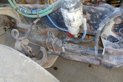 Peterbilt 357 dump truck chassis showing hydraulic lines and a filter canister undercarriage components.