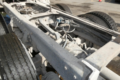 Peterbilt truck chassis frame and wheel area with exposed drivetrain components and suspension; gray metal frame and dual rear tires visible.